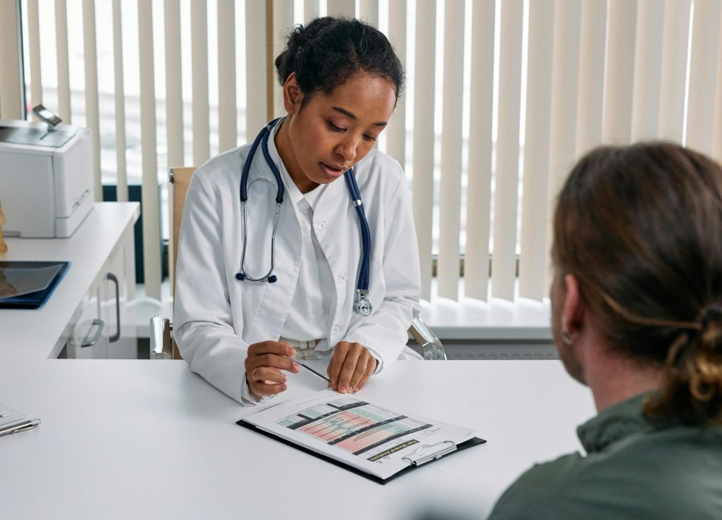 Woman discussing hormone test results with doctor.