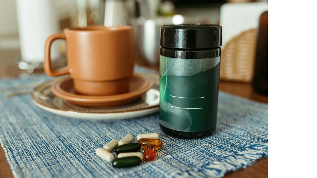 Natural supplements on a table next to a warm drink, representing gentle support for balancing hormones naturally alongside daily habits.