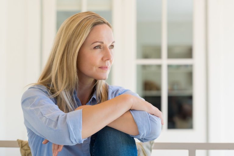 Hormone imbalance and fertility women over 35 represented by a reflective midlife woman sitting by a window