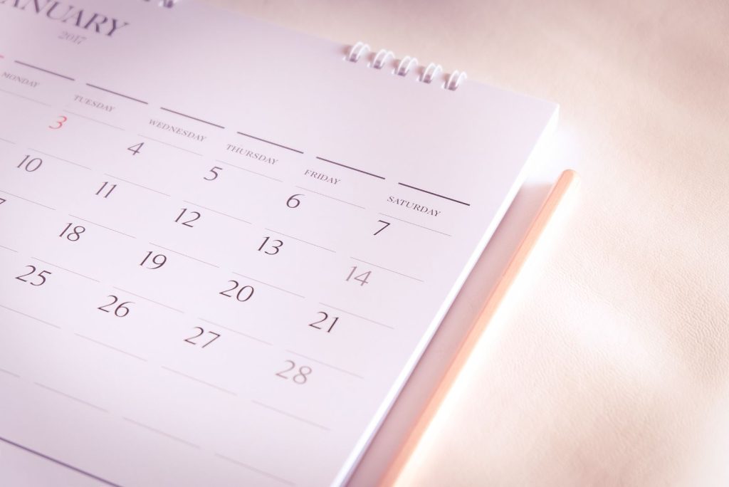 Calendar representing the timeline of postpartum hormone imbalance recovery over several months.